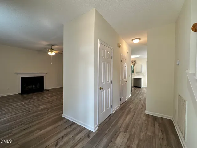 a view of a hallway with wooden floor