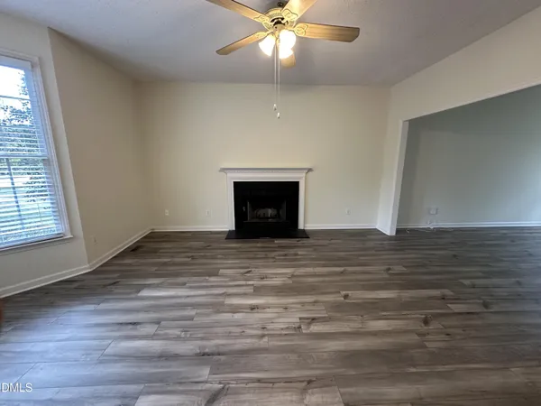 wooden floor in an empty room with a fireplace