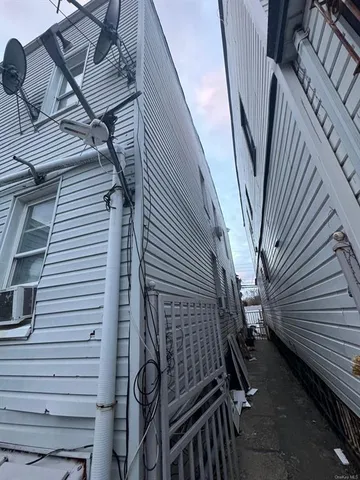 a view of a house with wooden fence