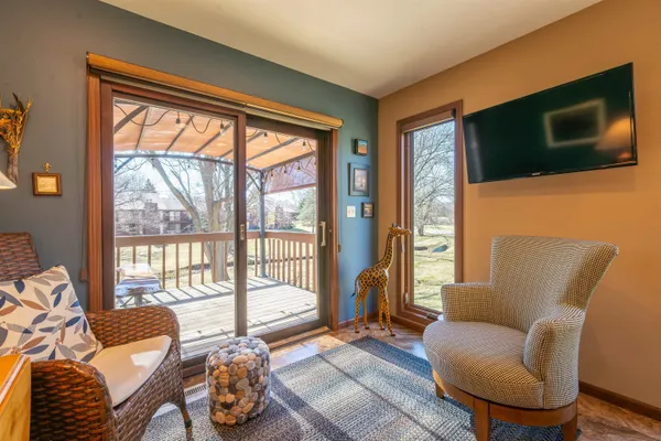 a living room with furniture tv and a floor to ceiling window