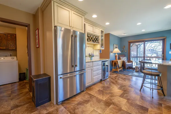 a kitchen with stainless steel appliances granite countertop a refrigerator stove and sink