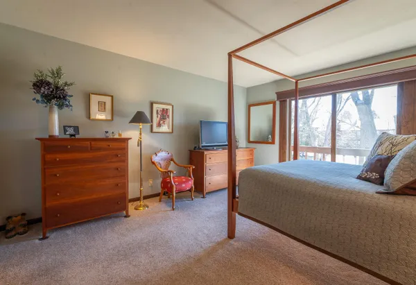 a bedroom with a bed and a dresser