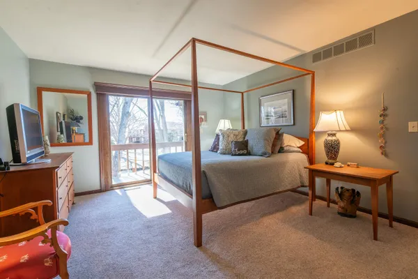 a bedroom with furniture and a flat screen tv