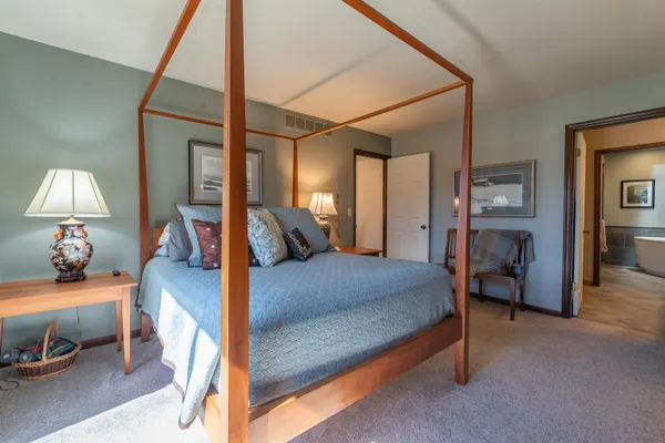 a bed room with a bed and a lamp