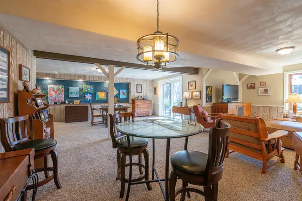 a view of a dining room with furniture and a chandelier