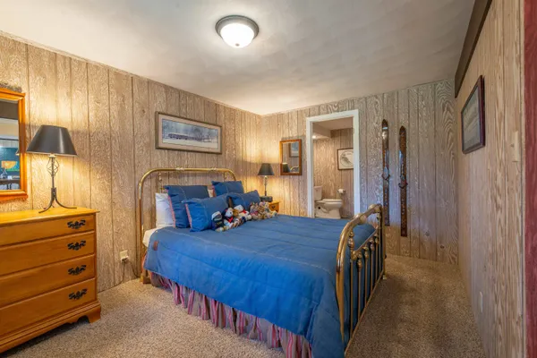 a bed room with a bed and a dresser