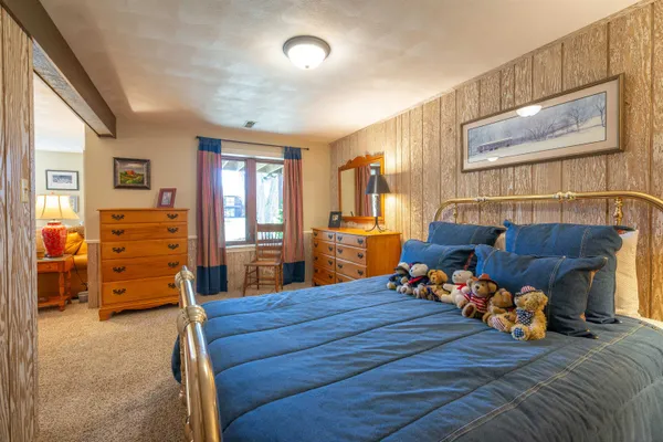 a bed room with furniture and a flat screen tv