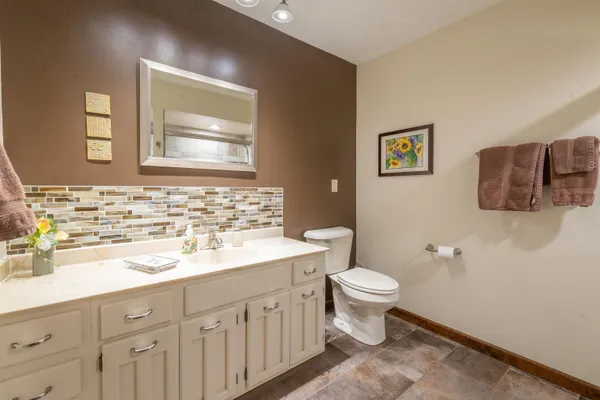 a bathroom with a sink toilet and mirror