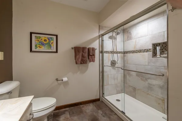 a bathroom with a toilet and a shower