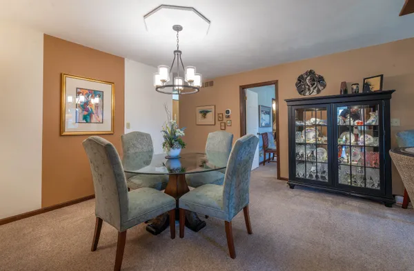 a view of a dining room with furniture and chandelier