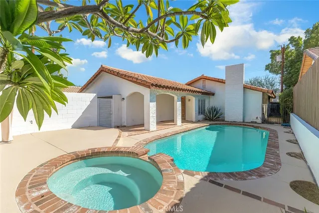 a swimming pool with outdoor seating and yard