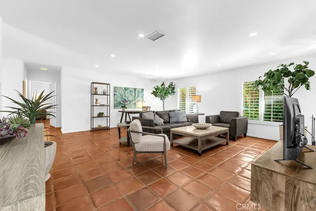 a living room with furniture a large window and a flat screen tv
