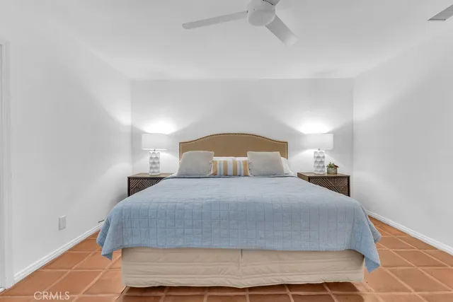 a bedroom with a bed and a night stand