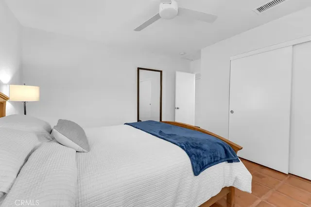 a bedroom with a bed and a lamp