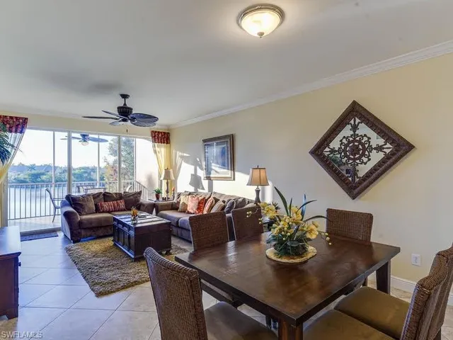 a view of a dining room with furniture large windows and wooden floor