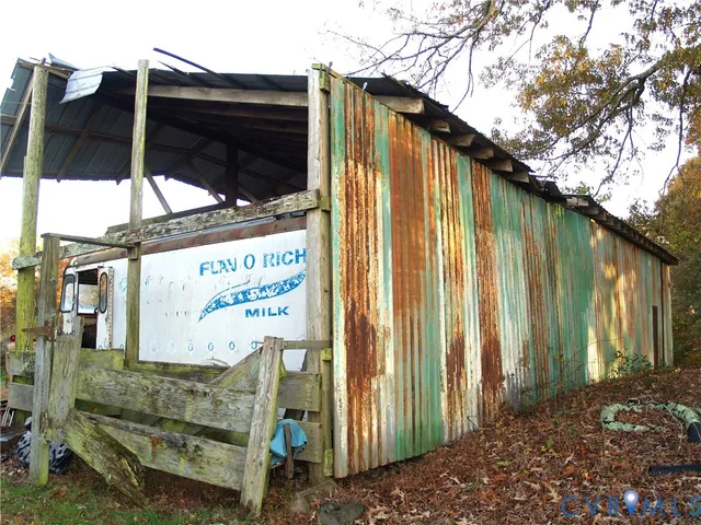 a view of patio with a table and chairs under an umbrella