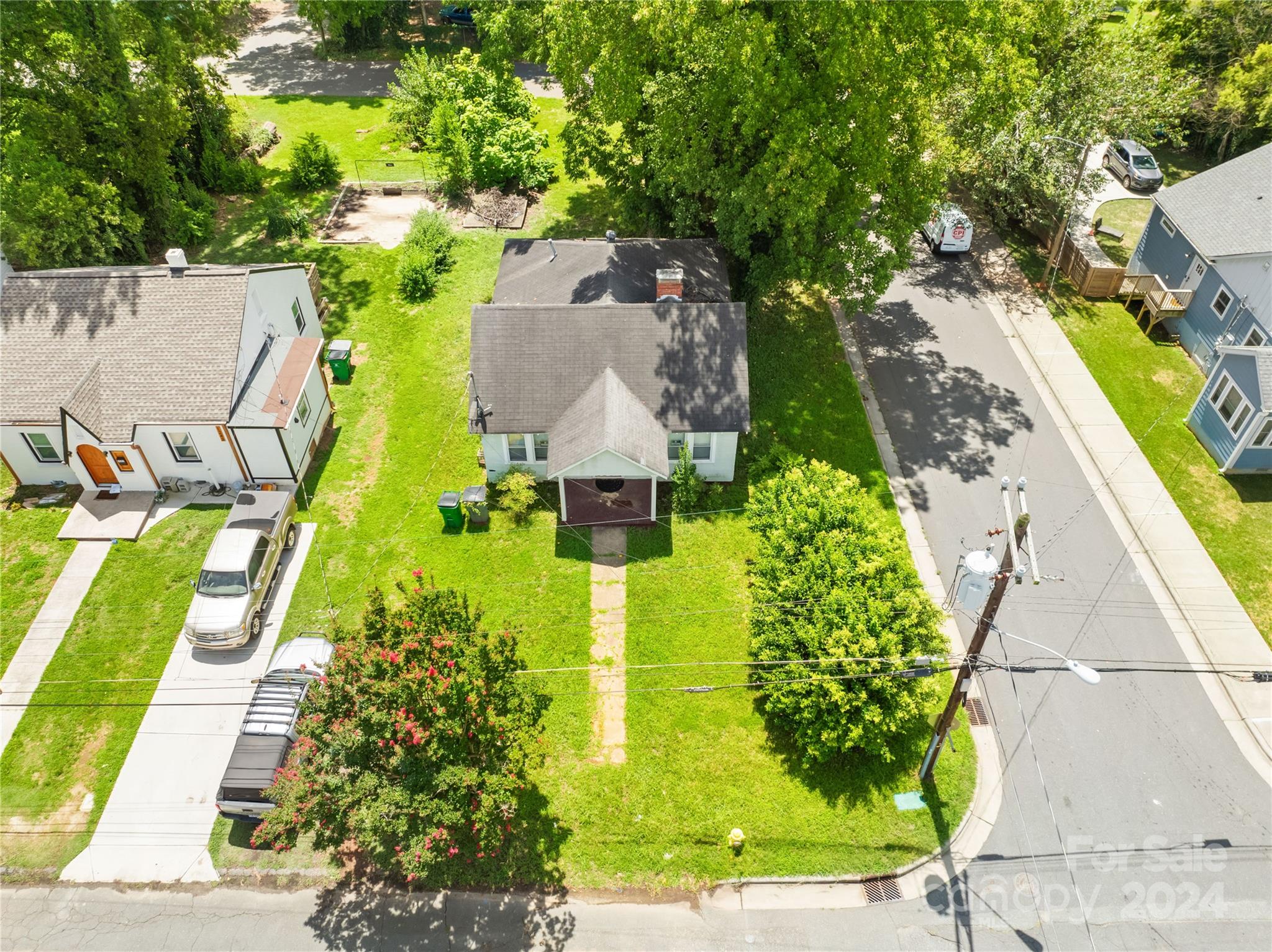 an aerial view of a house with swimming pool and garden