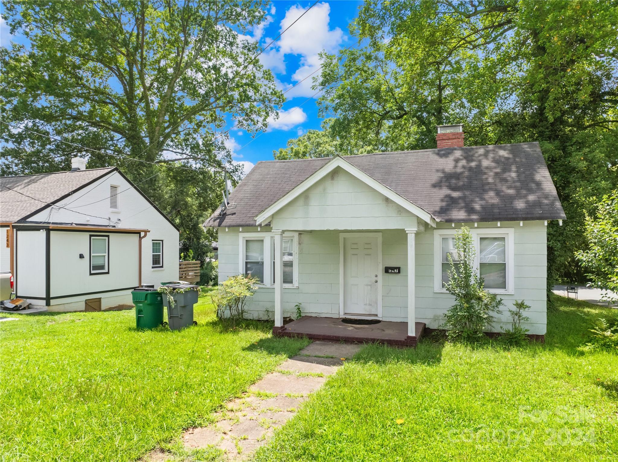 1247 Effingham Road Charlotte, NC 28208 - Photo 4 of 19 a view of a house with a yard and potted plants