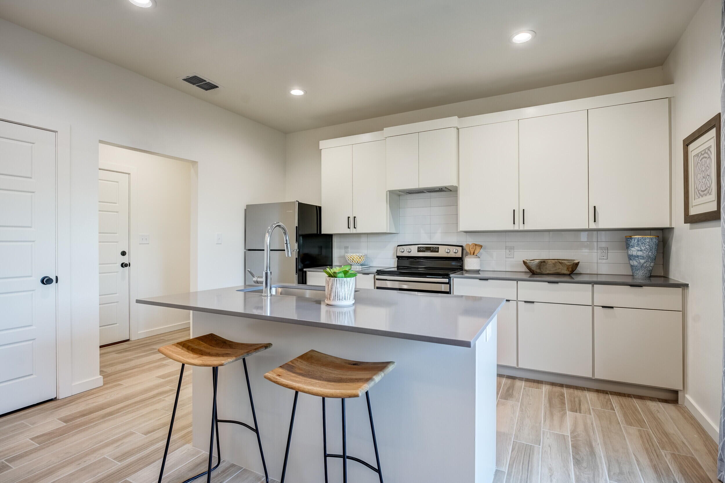 310 Homestead Avenue, Unit 4 Lubbock, TX 79416 - Photo 11 of 29 a kitchen with stainless steel appliances granite countertop a stove a sink dishwasher and a refrigerator with wooden floor