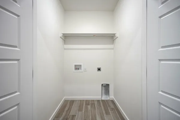 an empty room with a window and ceiling fan