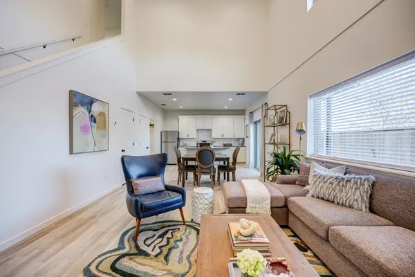a living room with furniture and a painting on the wall