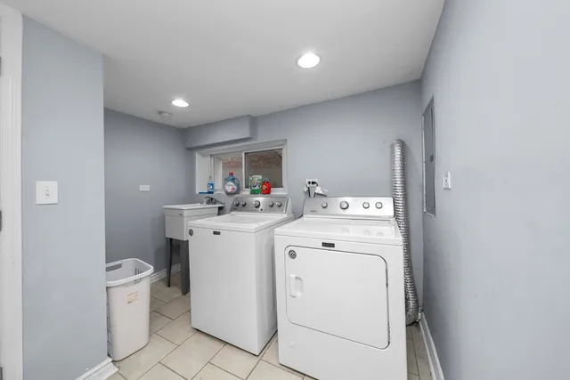 a view of storage and utility room with washer and dryer