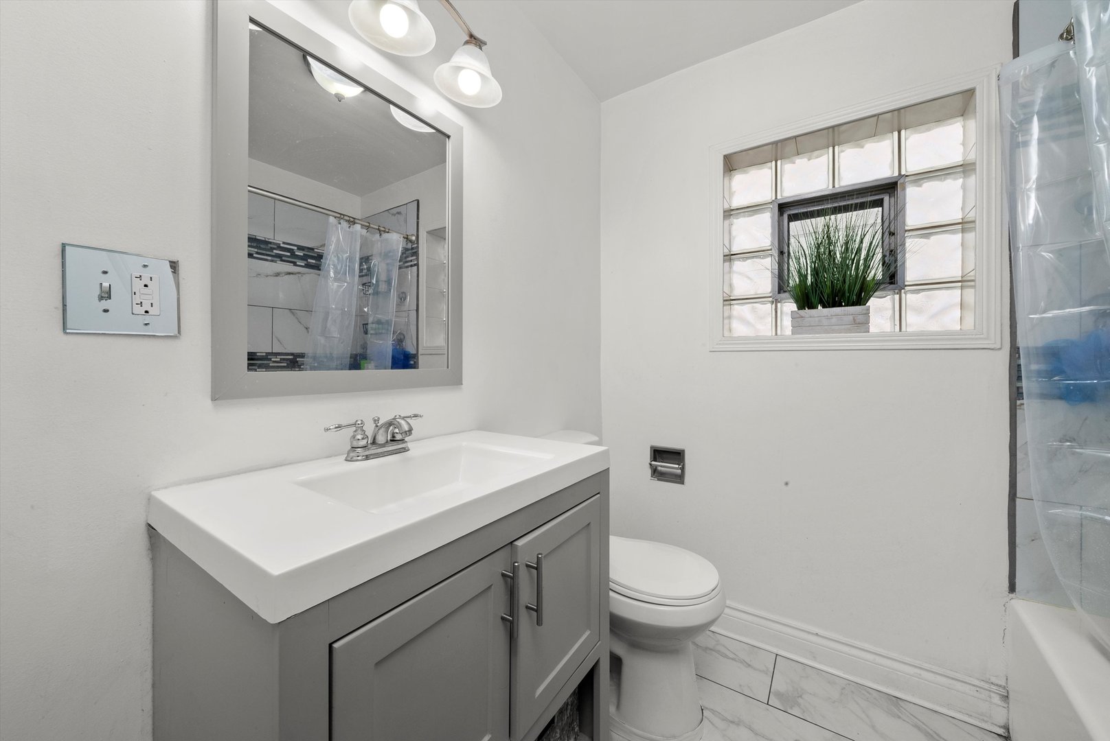 5837 West 16th Street Cicero, IL 60804 - Photo 19 of 22 a bathroom with a toilet sink and mirror