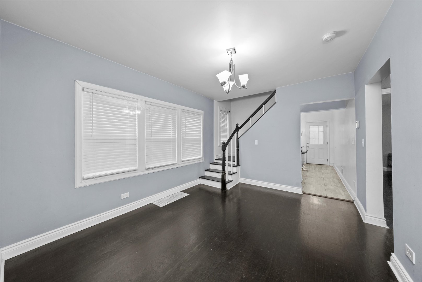 5837 West 16th Street Cicero, IL 60804 - Photo 6 of 22 an empty room with wooden floor chandelier and windows