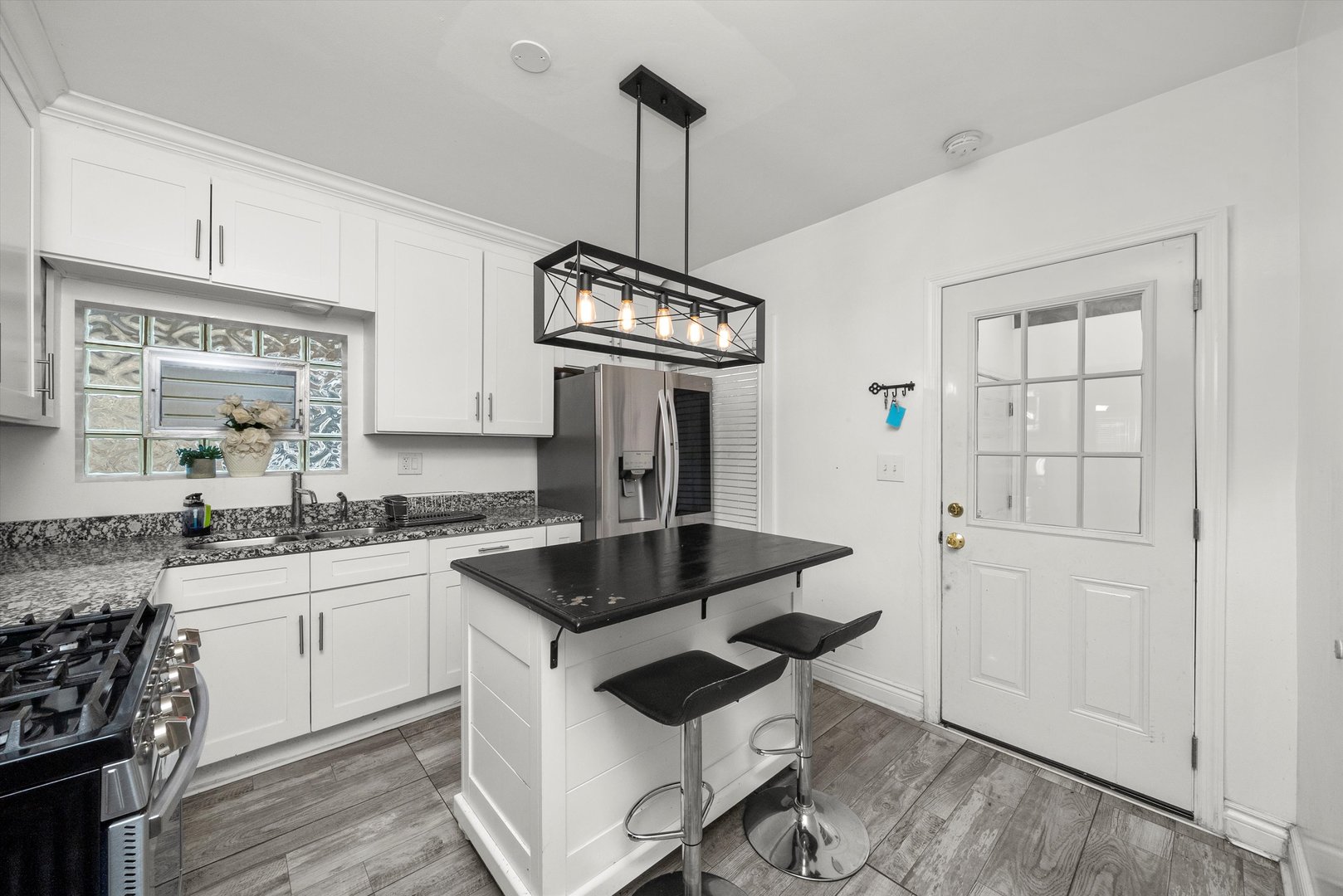 5837 West 16th Street Cicero, IL 60804 - Photo 9 of 22 a kitchen with granite countertop a sink a stove and refrigerator