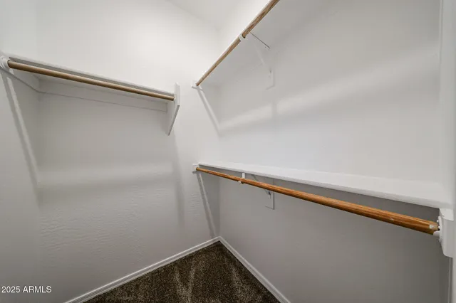 a view of closet with wooden floor