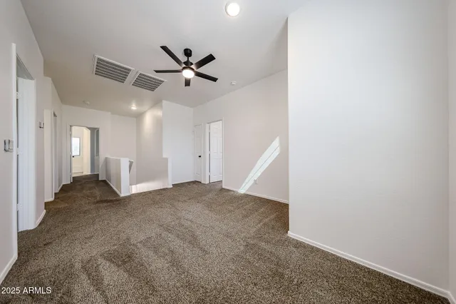 a view of a big room with closet and ceiling fan
