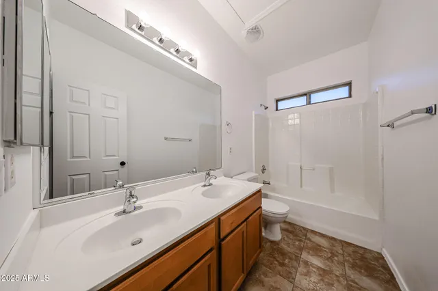 a bathroom with a double vanity sink mirror double and bathtub