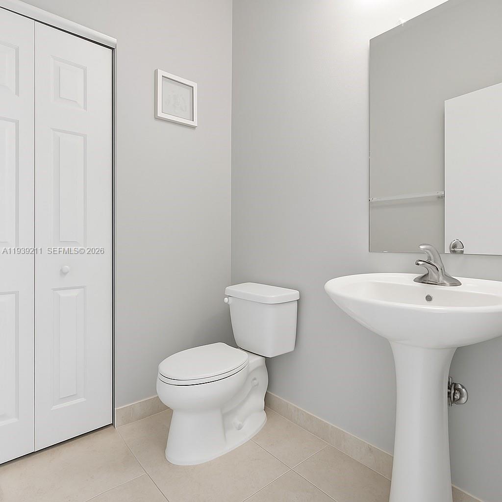 4581 Danson Way Delray Beach, FL 33445 - Photo 17 of 19 a bathroom with a toilet a sink and a mirror