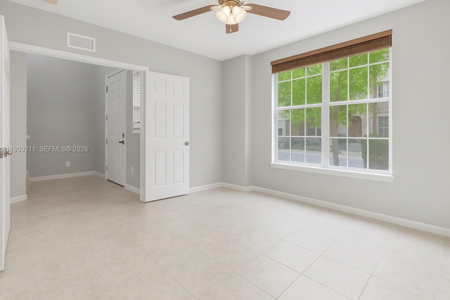 4581 Danson Way Delray Beach, FL 33445 - Photo 7 of 19 an empty room with a window and a ceiling fan