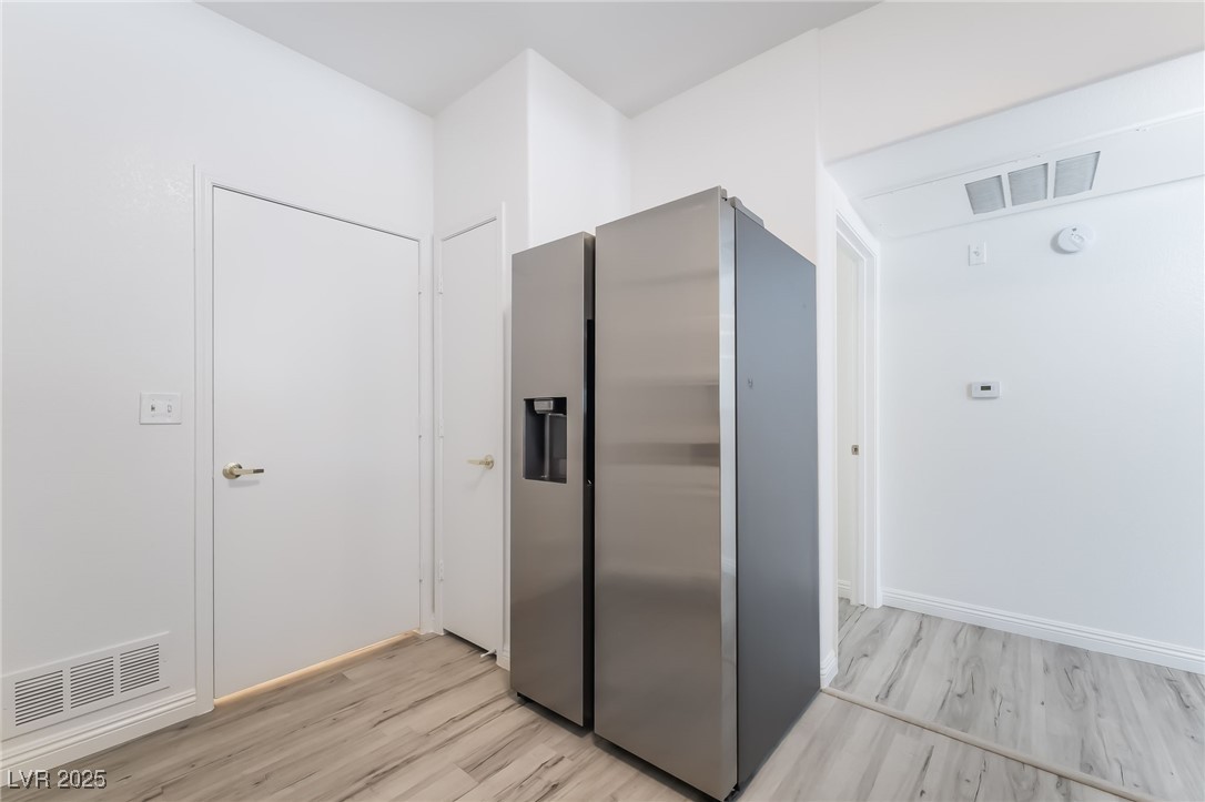 7255 West Sunset Road, Unit 1148 Las Vegas, NV 89113 - Photo 19 of 62 Kitchen with stainless steel fridge with ice dispenser and light wood-style flooring