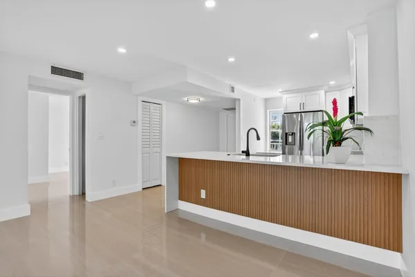 a view of kitchen with sink and window