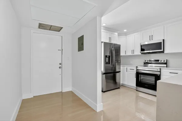 a kitchen with stainless steel appliances a refrigerator stove and microwave