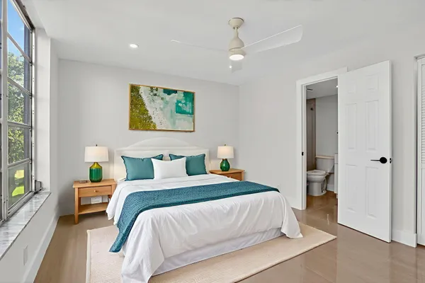 a bedroom with a bed and a painting