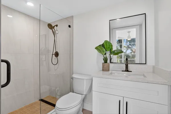 a bathroom with a sink toilet and shower