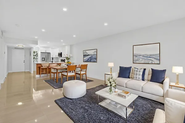 a living room with furniture and view of kitchen