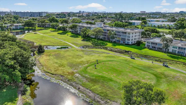 an aerial view of residential houses with outdoor space and swimming pool