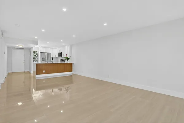 a view of kitchen with refrigerator sink and cabinets