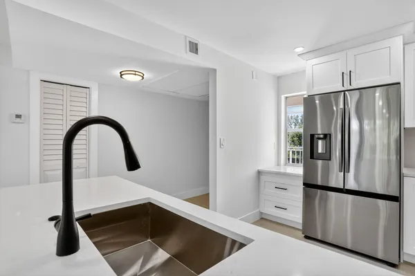 a kitchen with stainless steel appliances a refrigerator and a stove