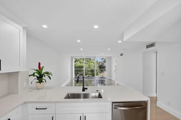 a kitchen with stainless steel appliances a counter space and a window