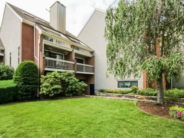 7 River Road, Unit 305 Cos Cob, CT 06807 - Photo 1 of 1 a view of a house with a yard and plants