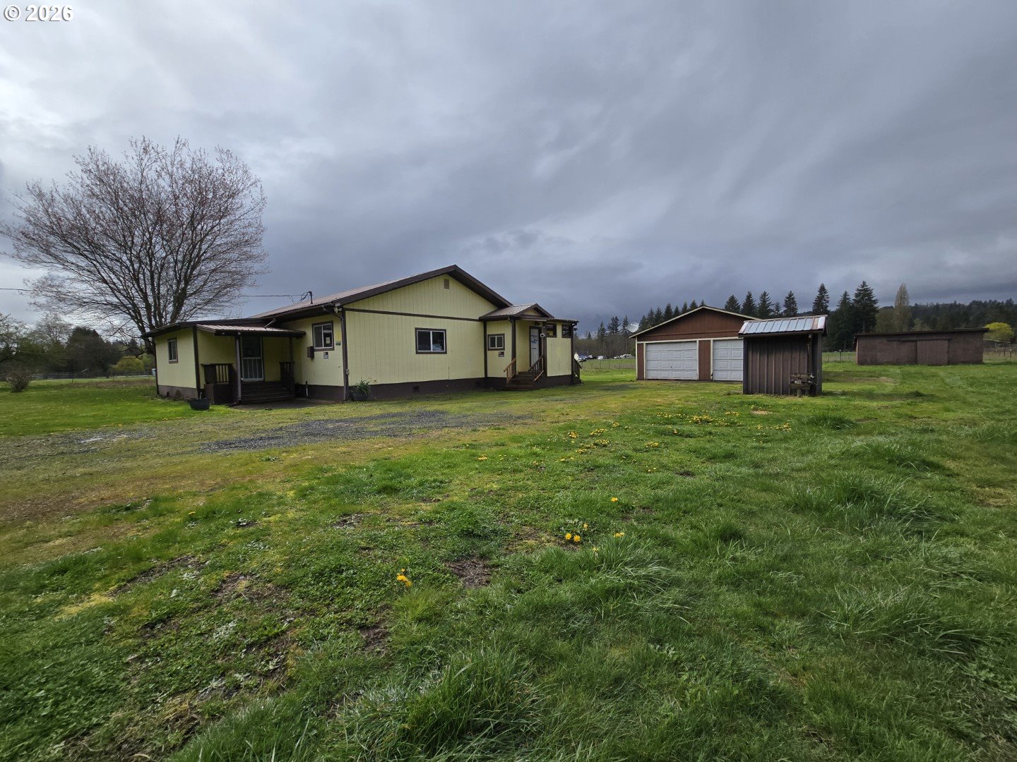 563 Shanklin Road Onalaska, WA 98570 - Photo 2 of 42 a view of a house with a big yard and large trees