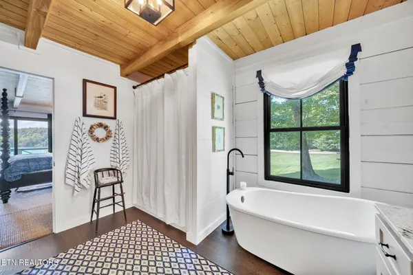 a bathroom with a granite countertop sink toilet and mirror