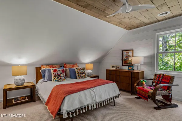 a bedroom with furniture and a bathtub