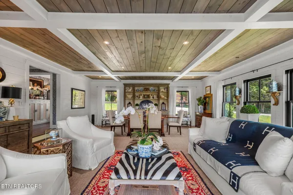 a living room with furniture and a chandelier