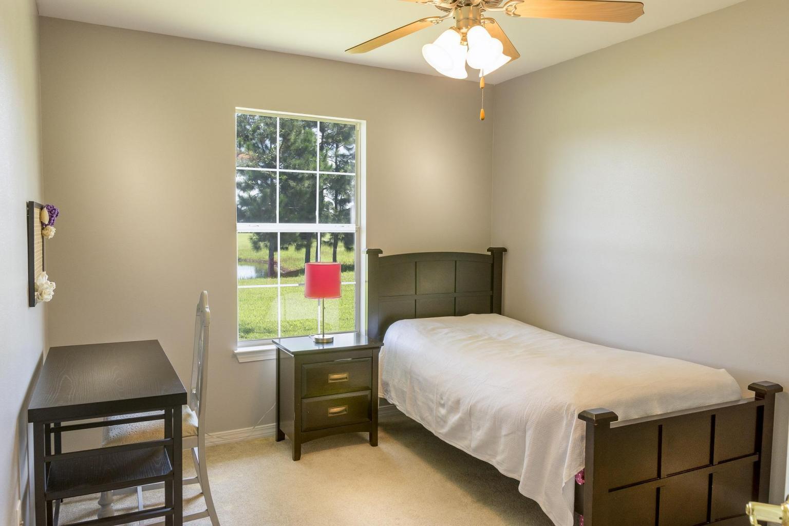 235 South Harborview Road Santa Rosa Beach, FL 32459 - Photo 9 of 12 a bedroom with a bed and a window
